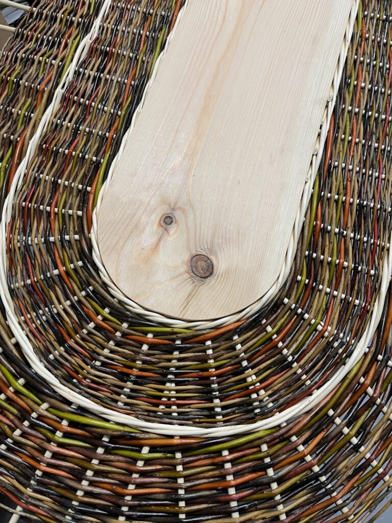 Close up of Colourful willow coffin lid with wooden centre