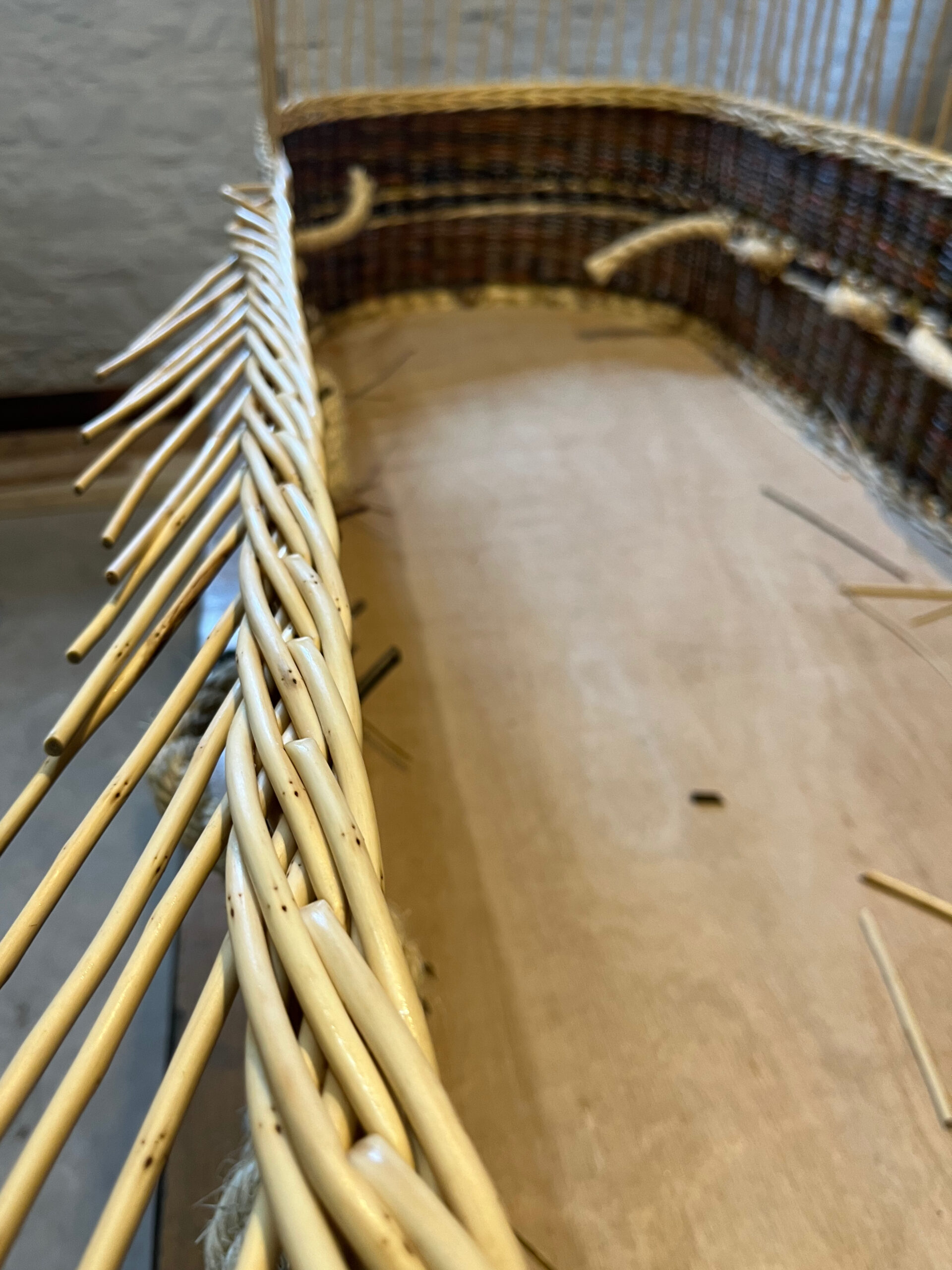 Ply base coffin with white willow side stakes being put down as a rod border.