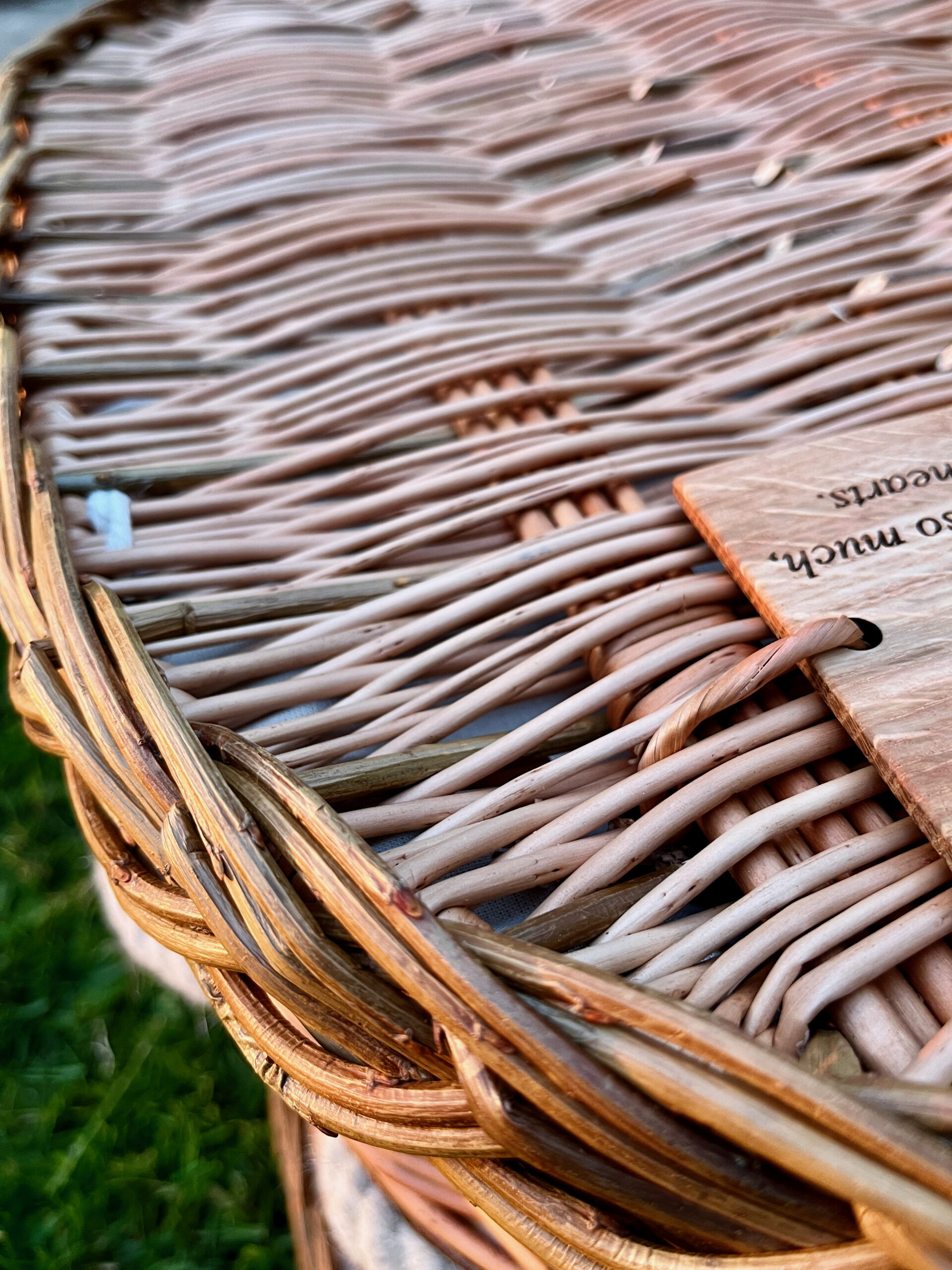 Name plate on woven buff coffin lid and attached with willow