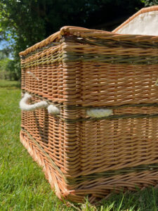 Side view showing the corner of a traditional shape willow coffin.