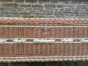Side details of buff and white willow coffin