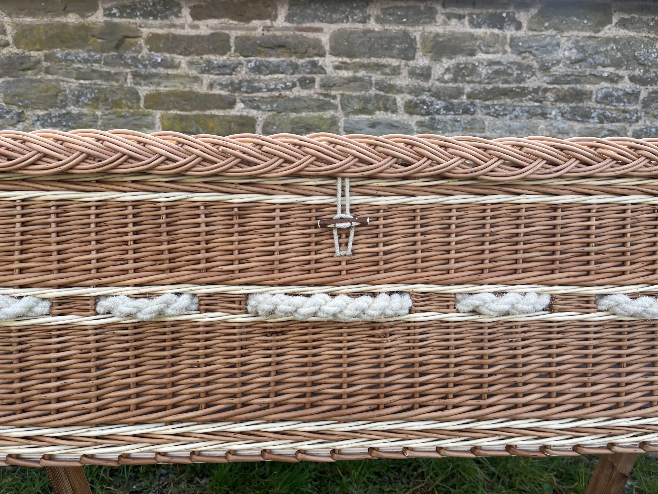 Side details of buff and white willow coffin