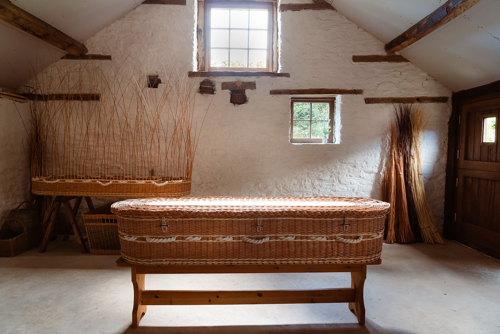 Willow coffins in the workshop on the table with early morning light shining in
